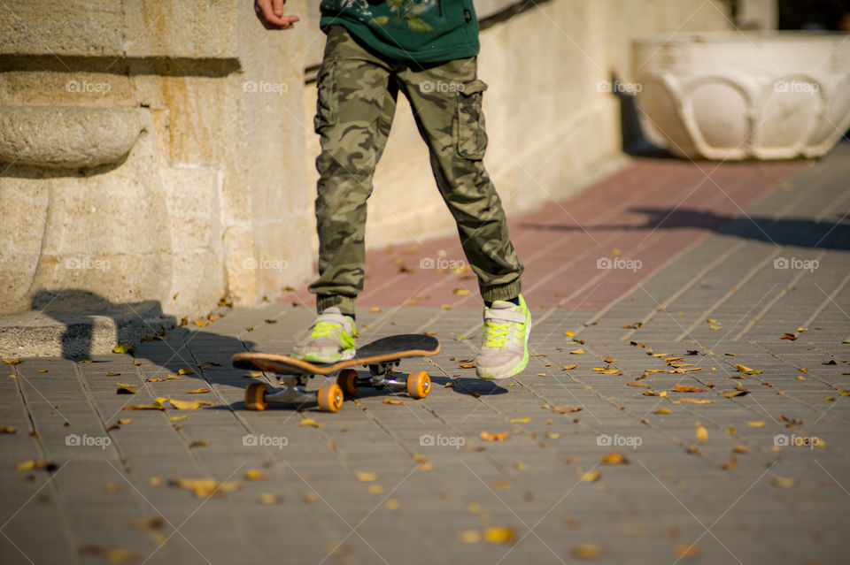 ride a skateboard on a warm autumn day
