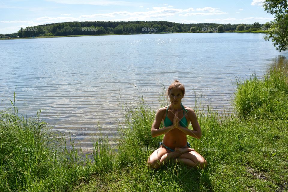 girl training yoga on a lake shore summer time, yoga outdoor