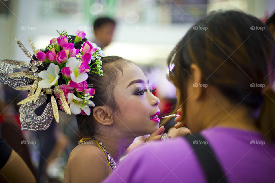 Make up artist for a pretty girl. women putting making on pretty girl wear costume preparing for the show