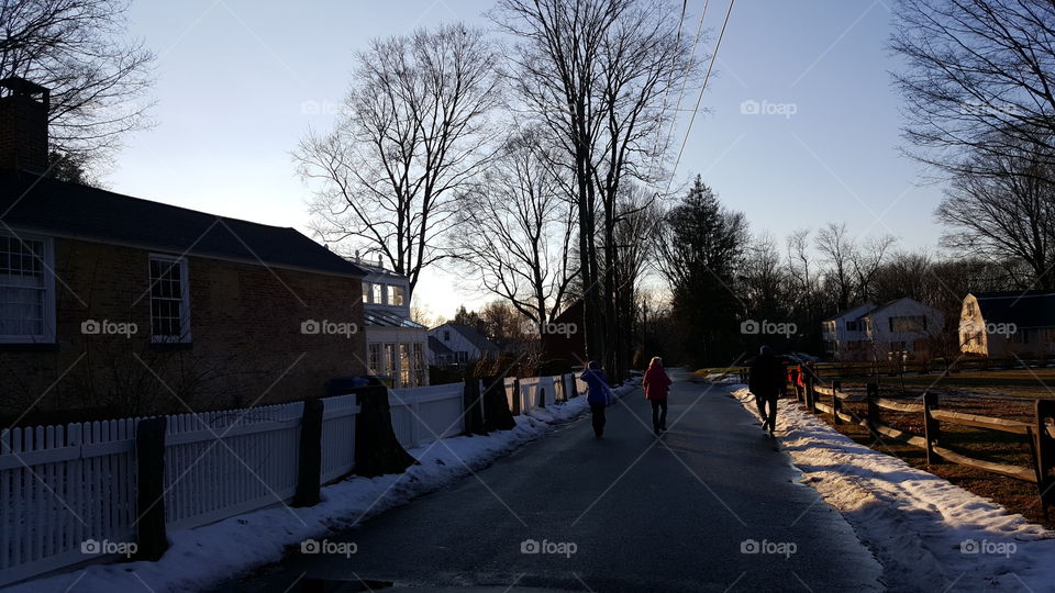 People walking on a snowy lane