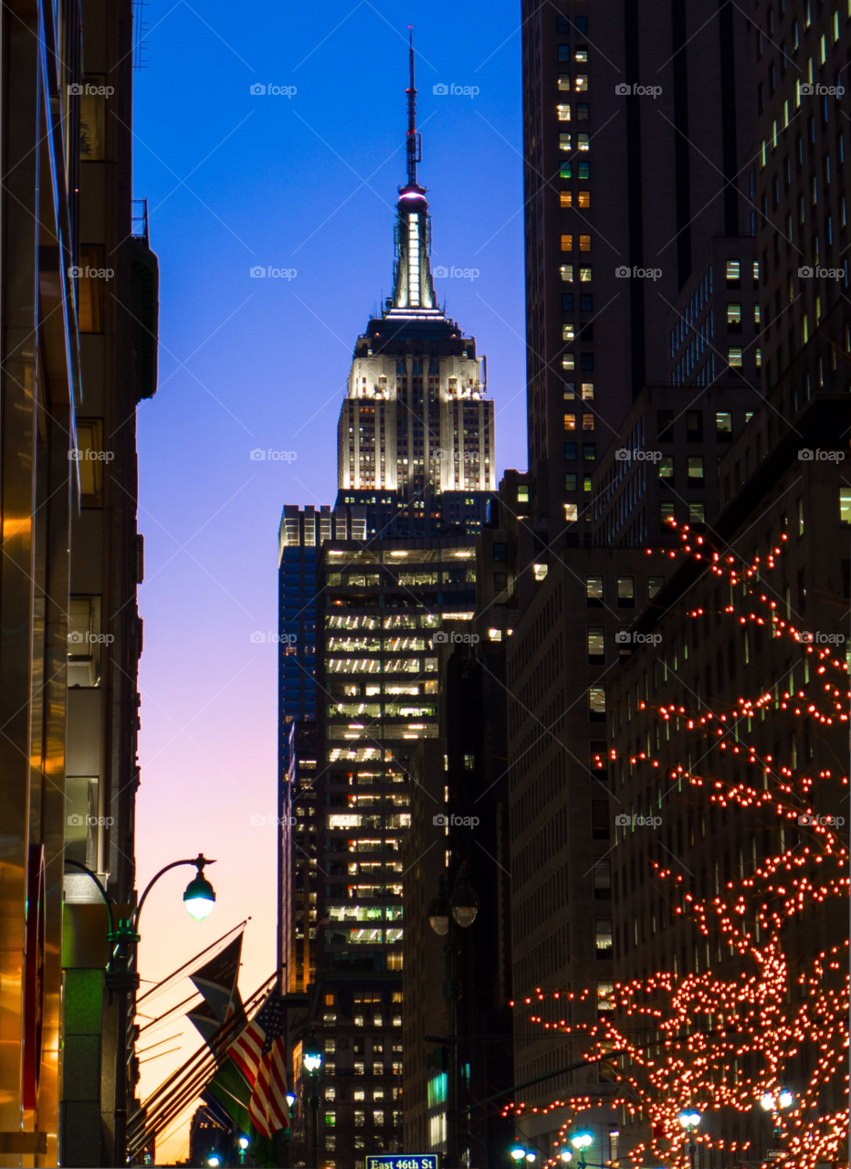 white lights blue sky empire state building by delvec