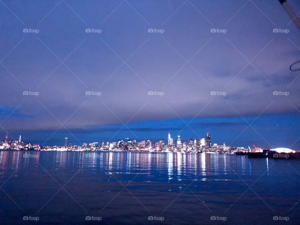 Skyline of Seattle, WA from Alki beach pier on a cold winter evening 
