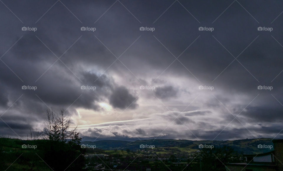 A gap in dark clouds over Newtown, Powys
