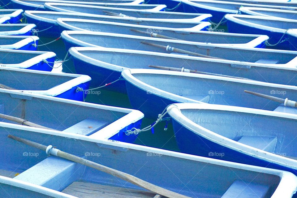 Blue boats moored at harbor