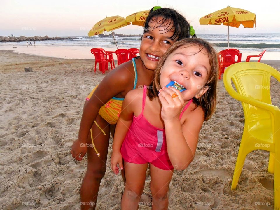 Happy sisters on the beach