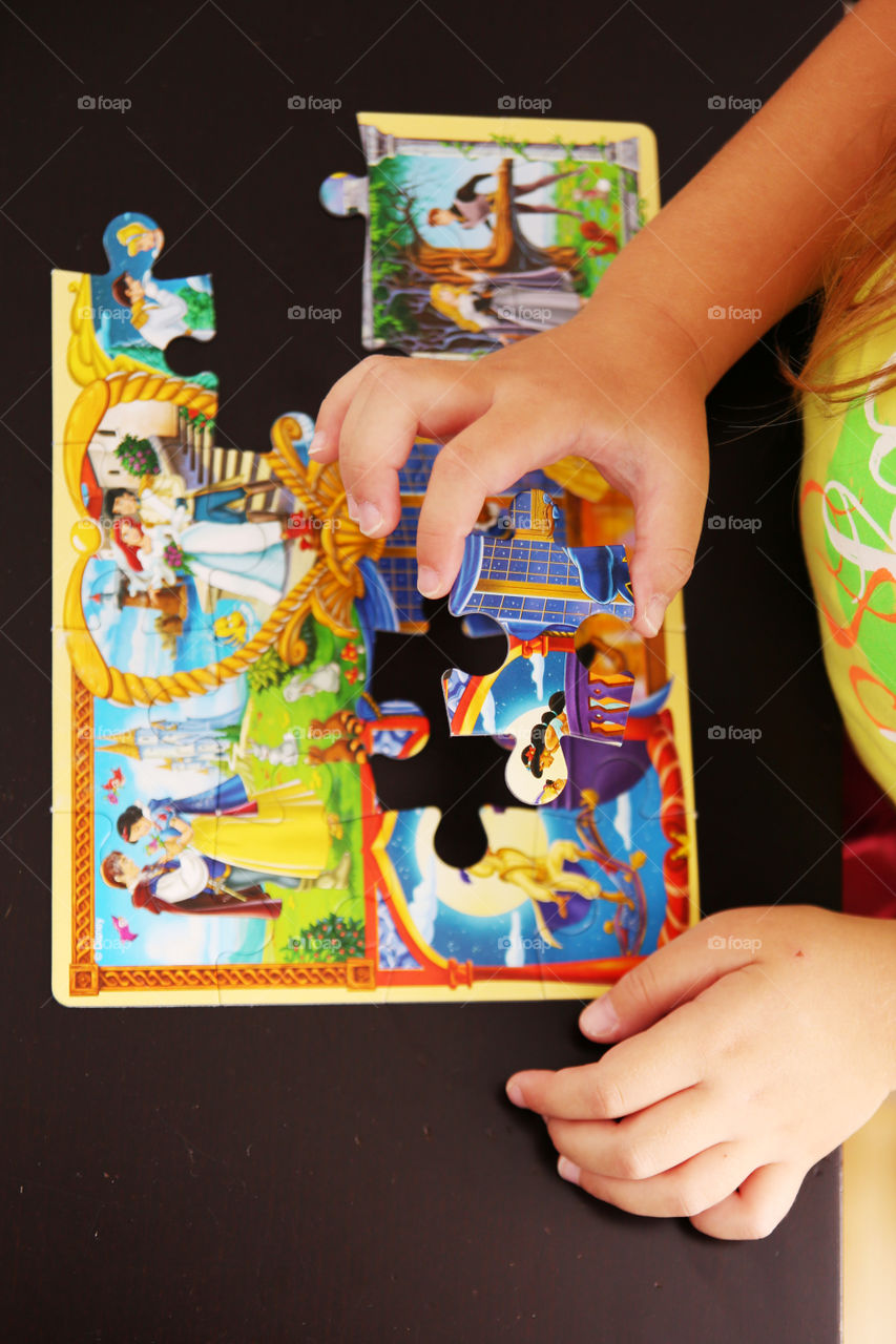 Child playing with puzzles at home