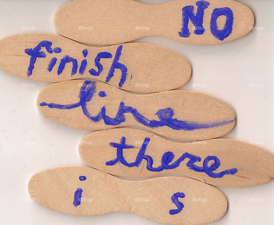 A version of a slogan painted onto wooden ice cream spoons.