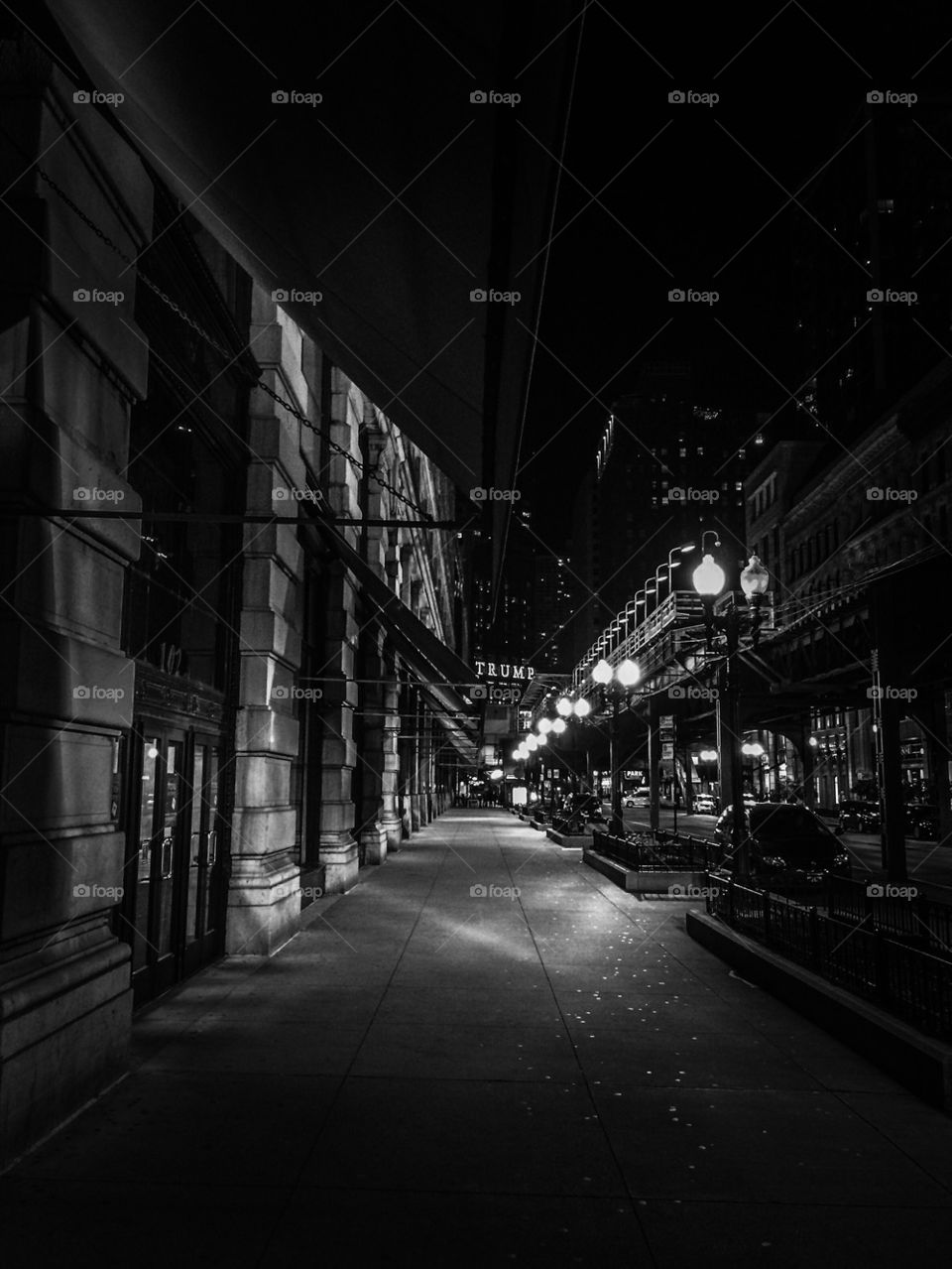 Empty walkway in city at night