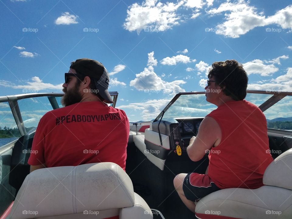 Father and son enjoying a beautiful day on the lake