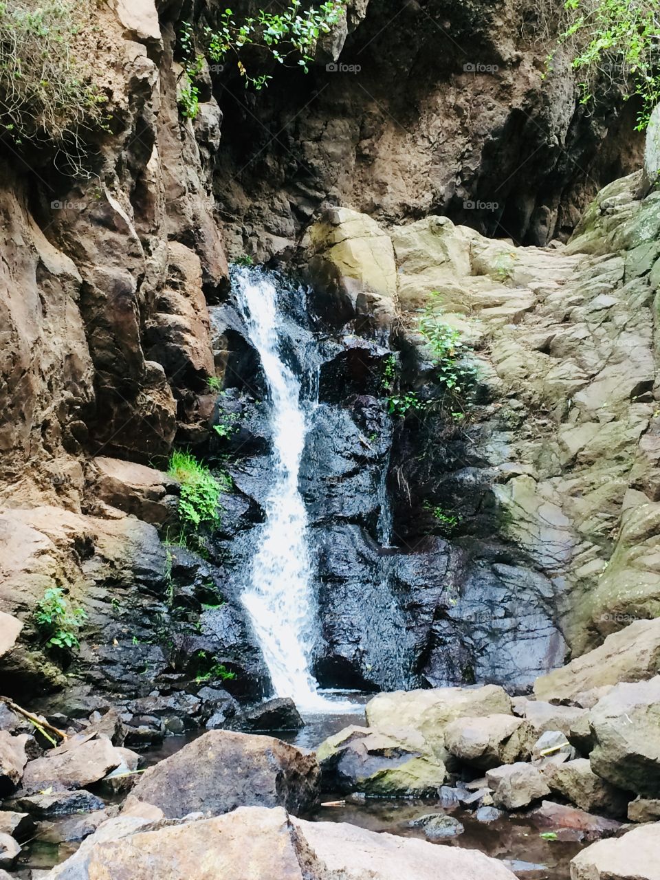 Mini waterfall flowing down the mountain 