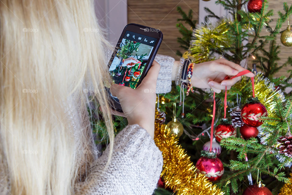 girl is decorating the Christmas tree