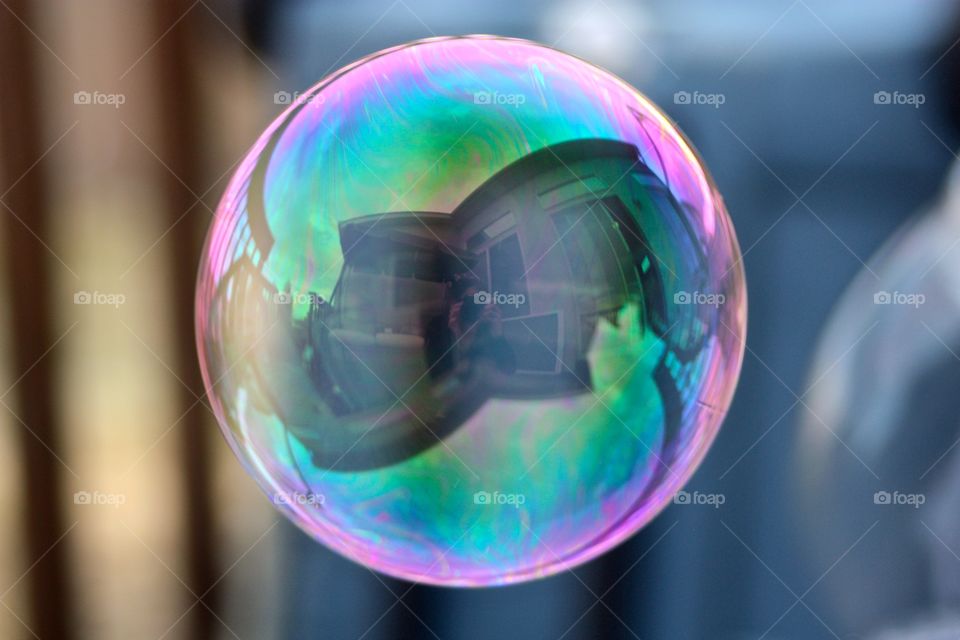 Reflection of woman photographing on bubble