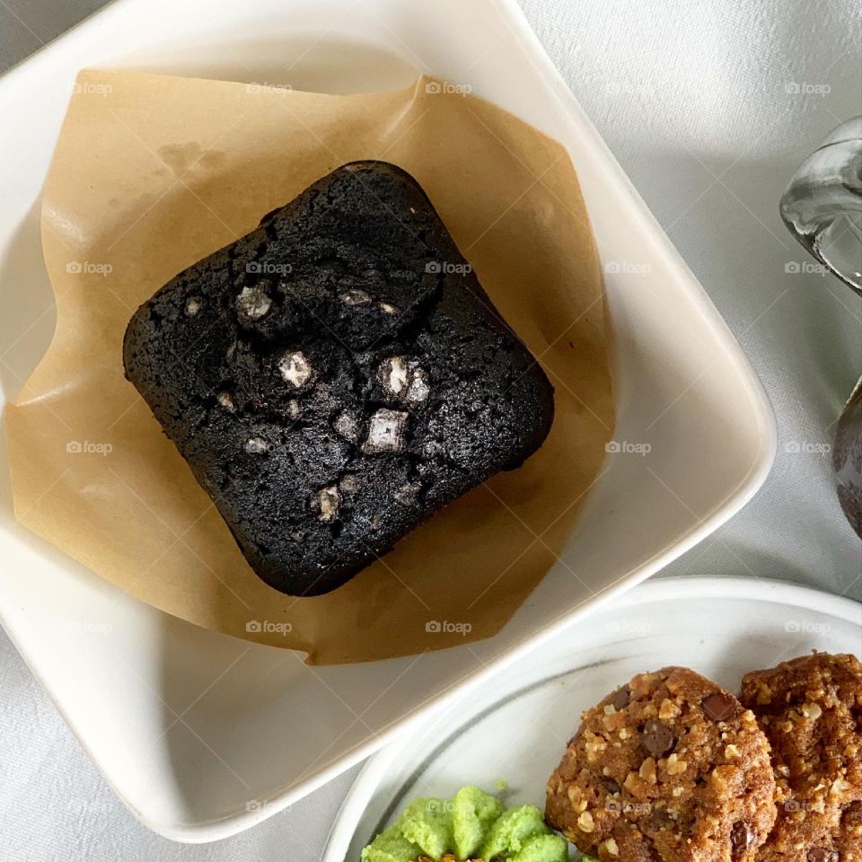 Afternoon snacks ondeh cookies and chocolate chip oat cookies with black brownie and sea salt and ice cold black coffee