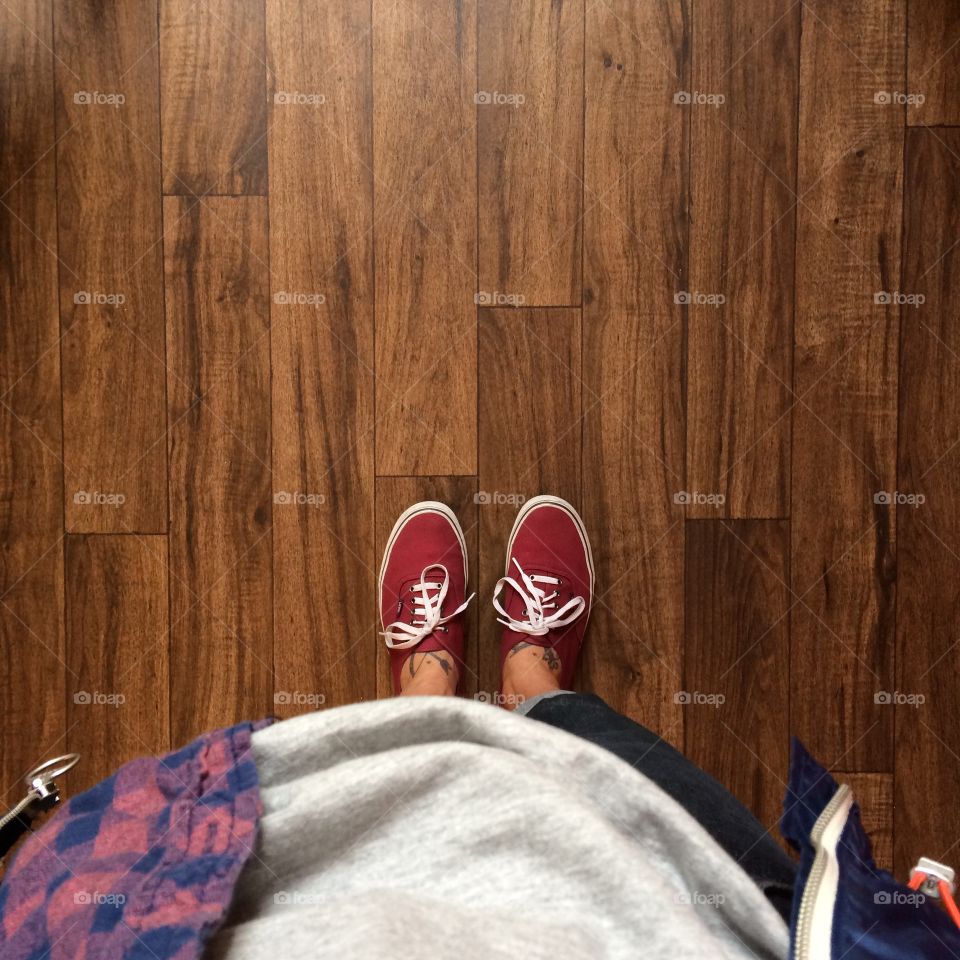 Feet in the light on the wood floor. 