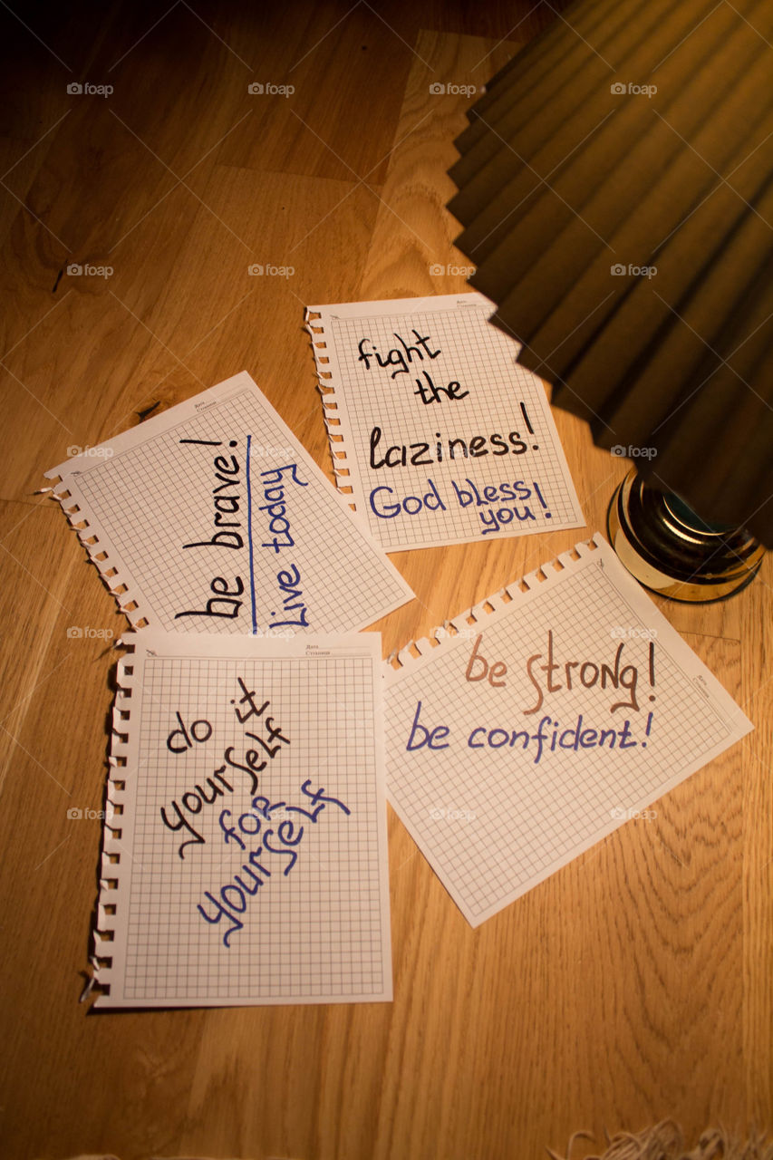 Motivational letter in a notebook on the desktop under the light of a lamp