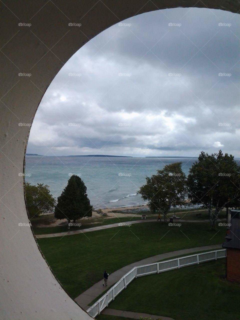 through the window . Lighthouse in mackinaw city 