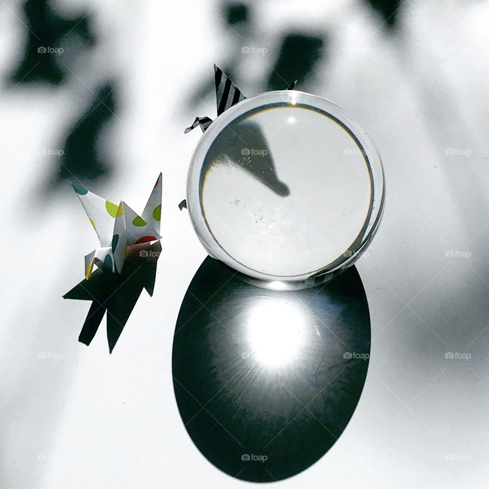 Two origami birds. One striped and one polka dot. Good and evil. The striped bird is stalking the polka dot bird.