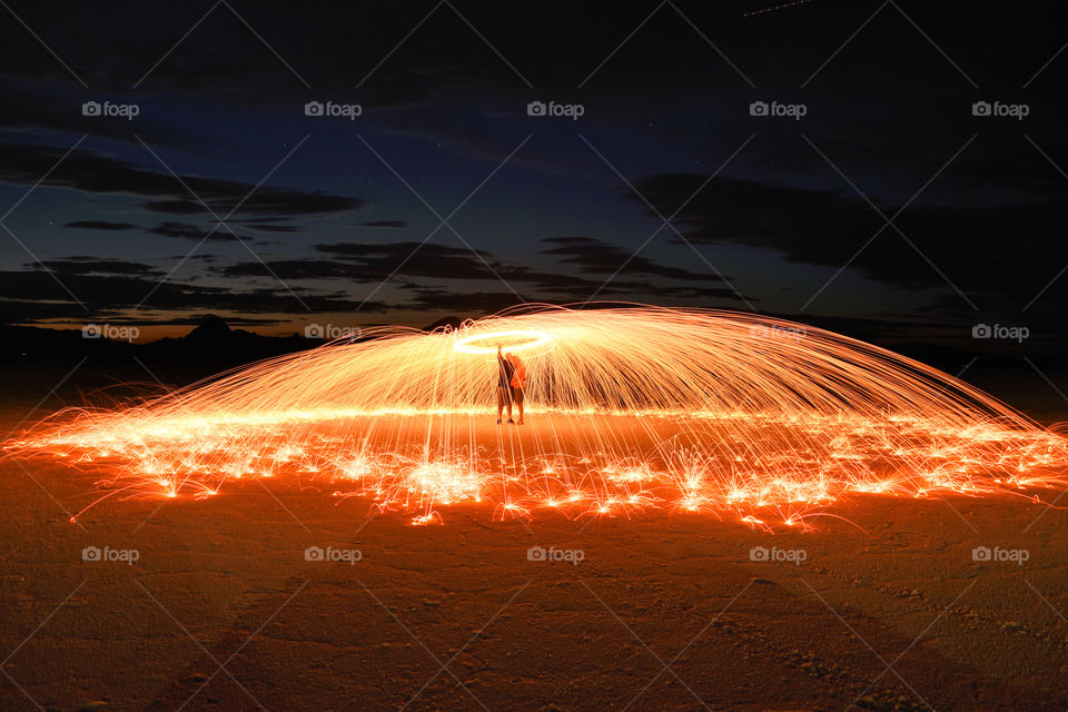 Couple under umbrella of spinning burning steel wool sparks! 