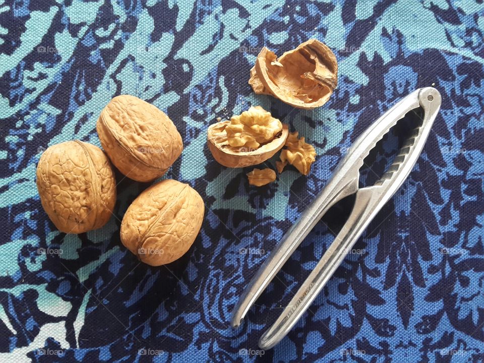 walnuts and a nutcracker on a blue tablecloth