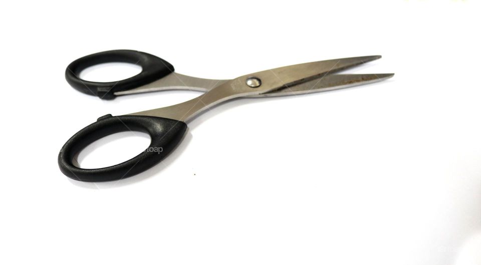 Photo of black scissors made of steel, this photo is on a white background