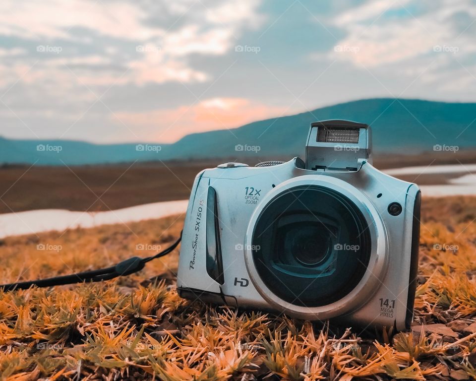 This photograph shows old digital camera in a beautiful and peaceful background.