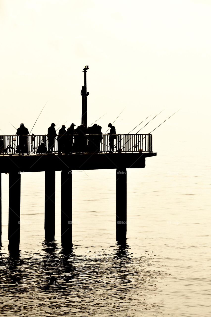 group of fishermen on the pier