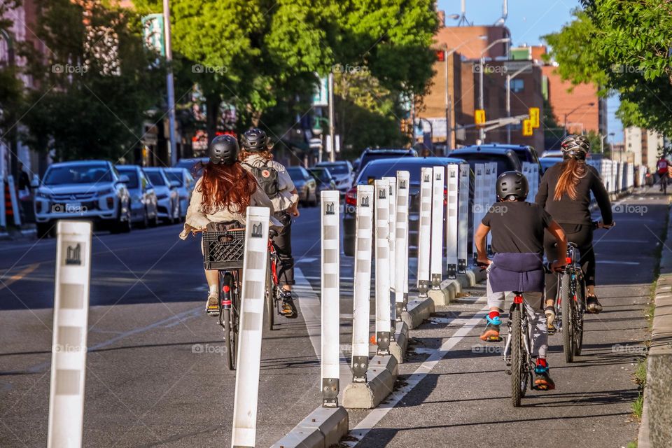 Teens are riding bikes on a city street