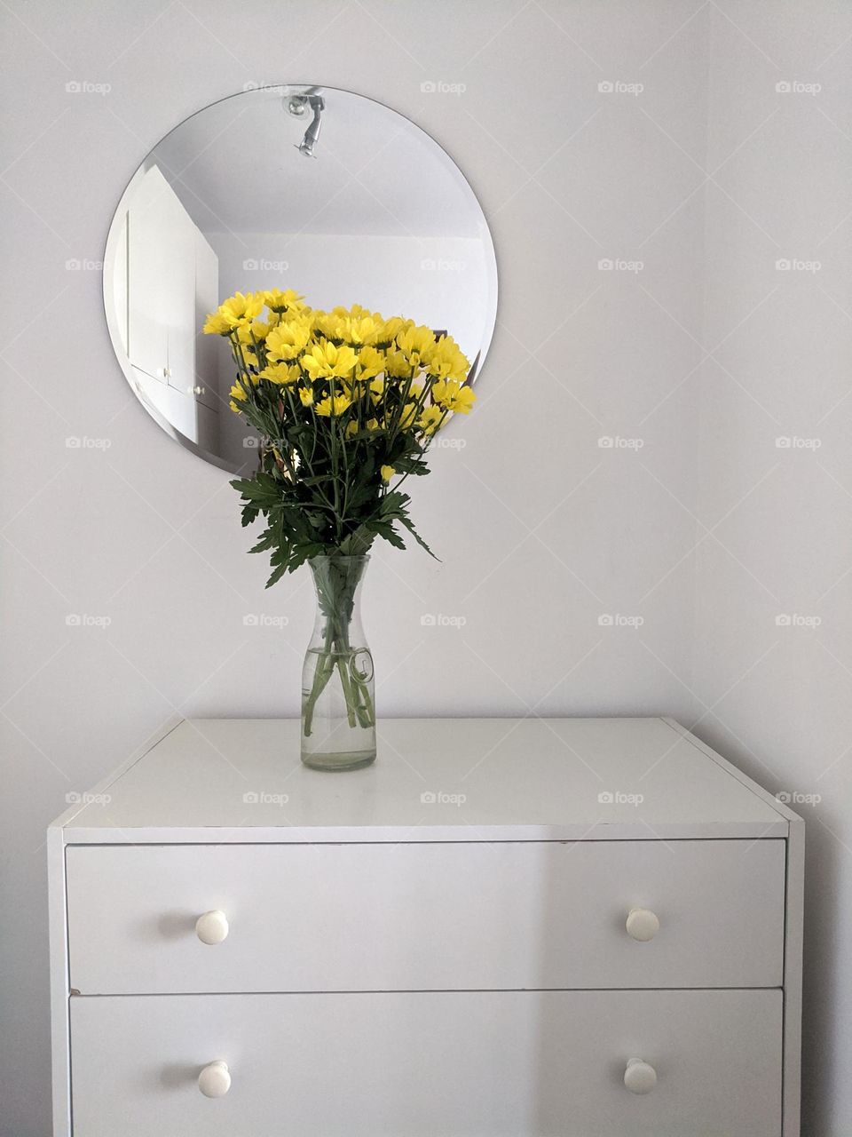 Top view of beautiful yellow, blooming flowers in a vase at the table.  Spring time