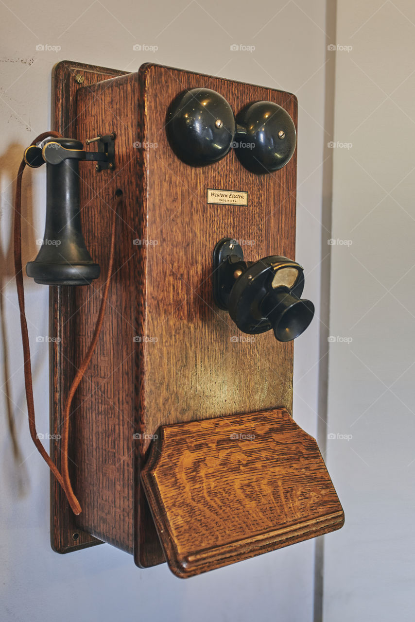old telephone hanging on the wall