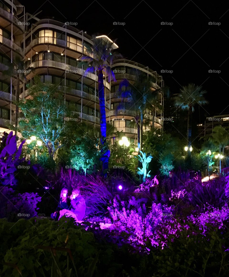 Young lovers with masks in park at Christmas night
