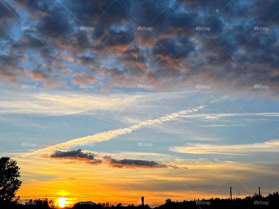 Stunning sunset view with different kind and form shape clouds on the blue sky 