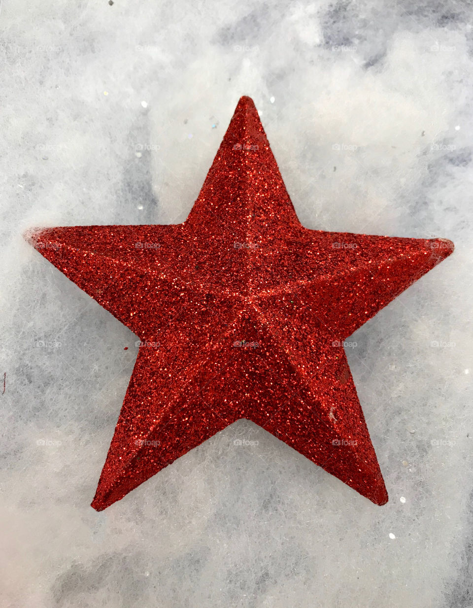 Red sparkly star against a white background