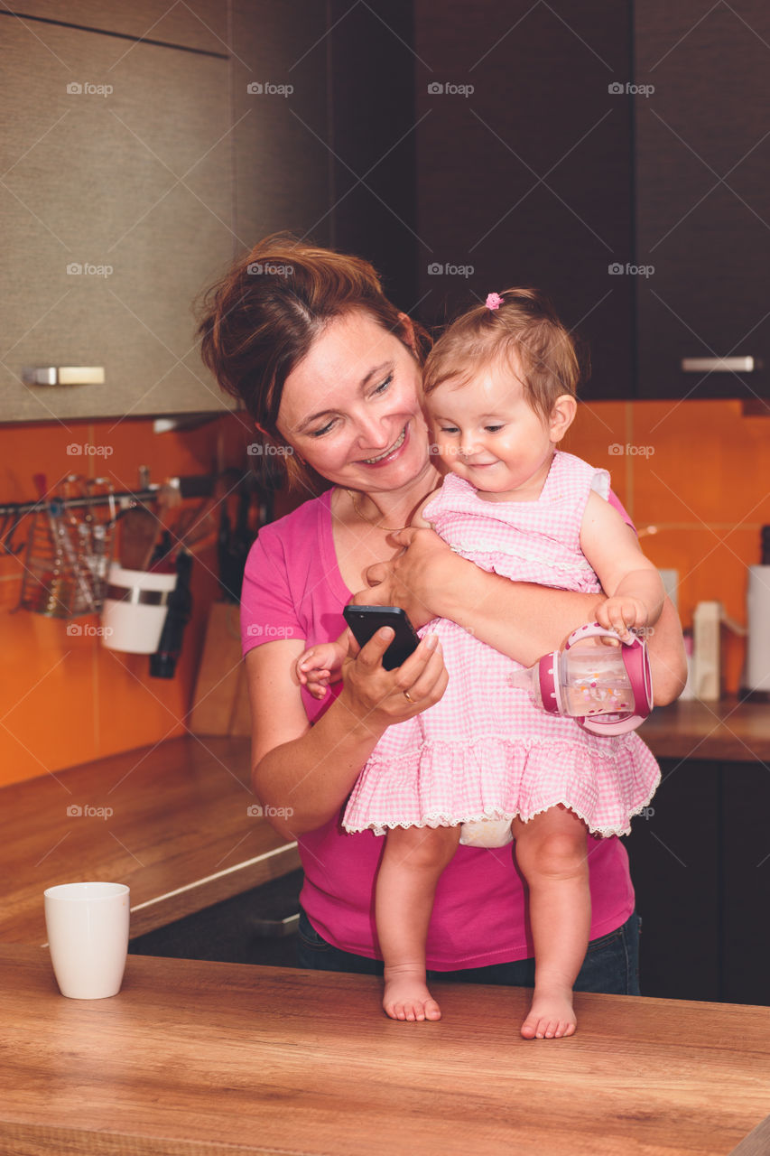 Video call with grandmother. Woman showing her little daughter video call with grandmother