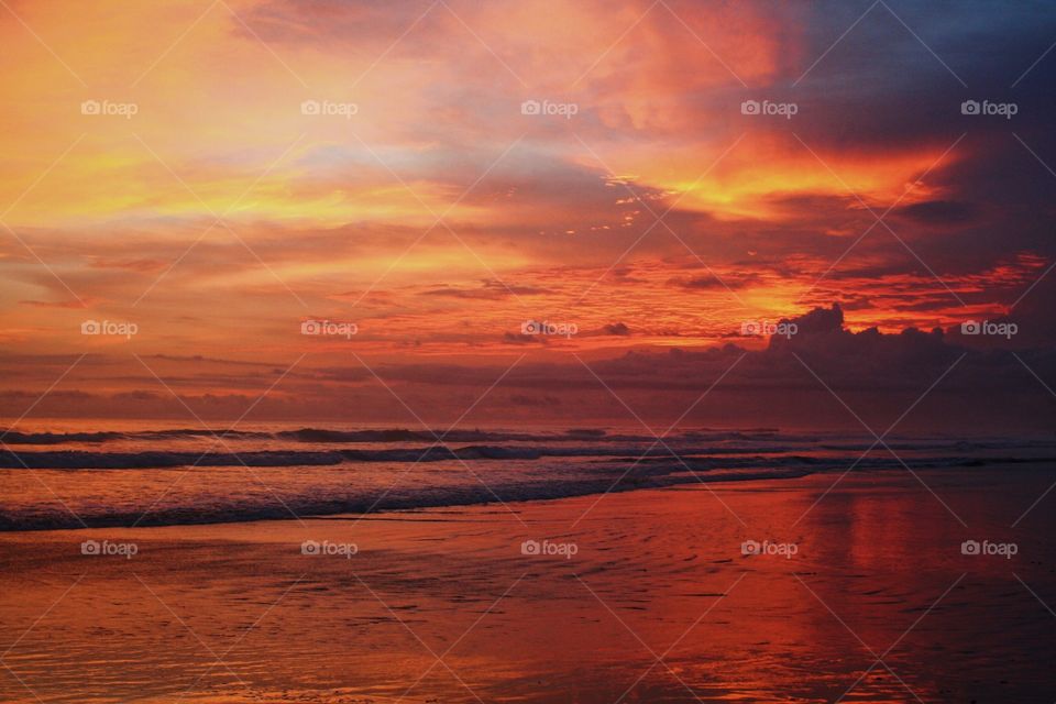 Sunset reflecting in wet sand