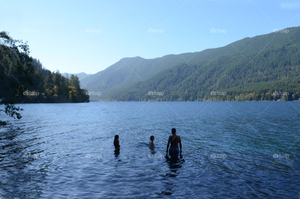 A group of friends swim in Lake Crescent in Olympic National Park of Washington state.