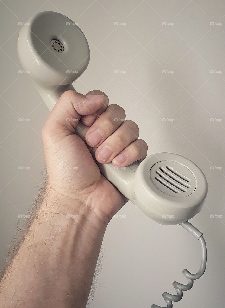 Hand holding old school telephone receiver 2