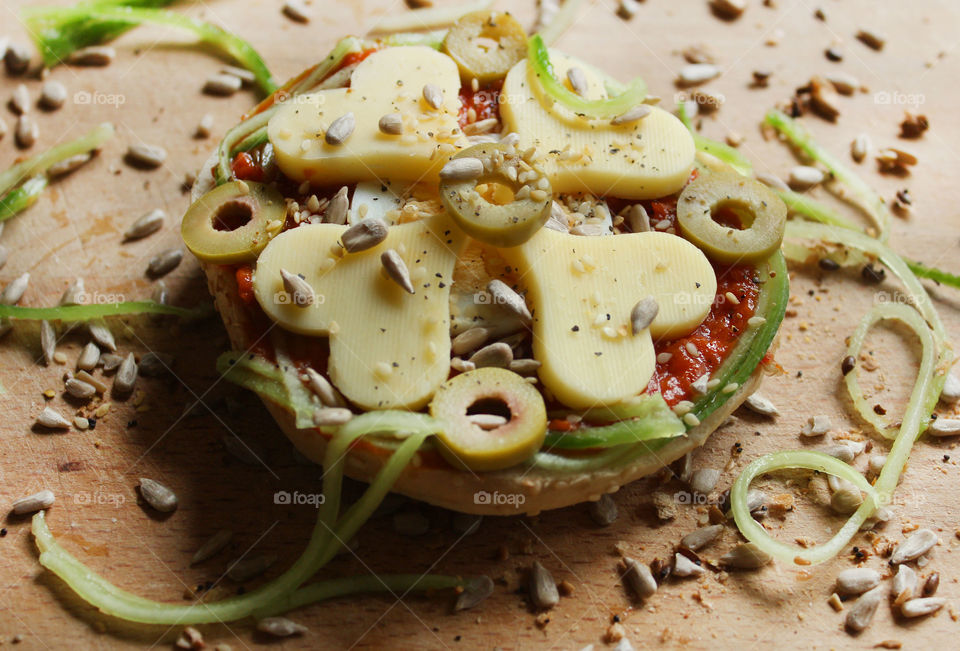 Love sandwich, heart shaped yellow cheese, tomato sauce, olives, an egg and seeds