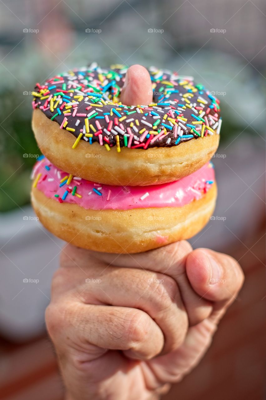 Doughnuts skewered on a finger