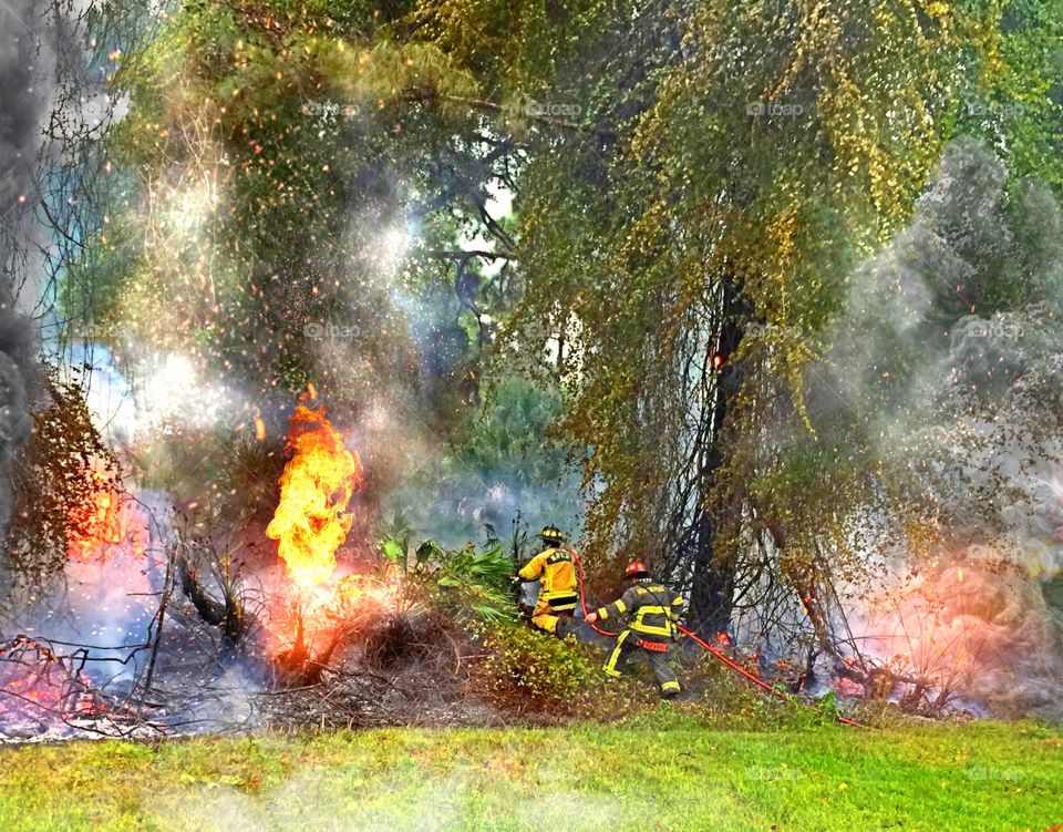 Brave firefighters. Brave firefighters combating a brush fire ignited by lightning.