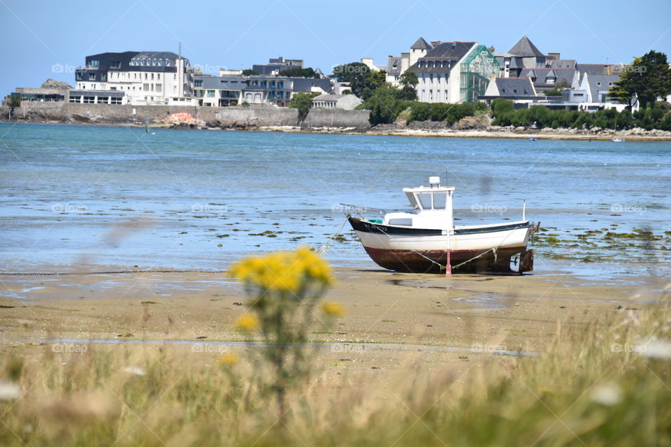 A boat on Sand during low tide 