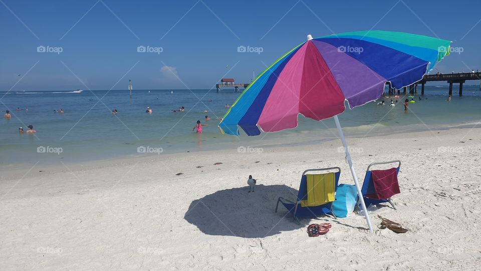 Beautiful day on the beach,  sun chairs and colorful umbrella