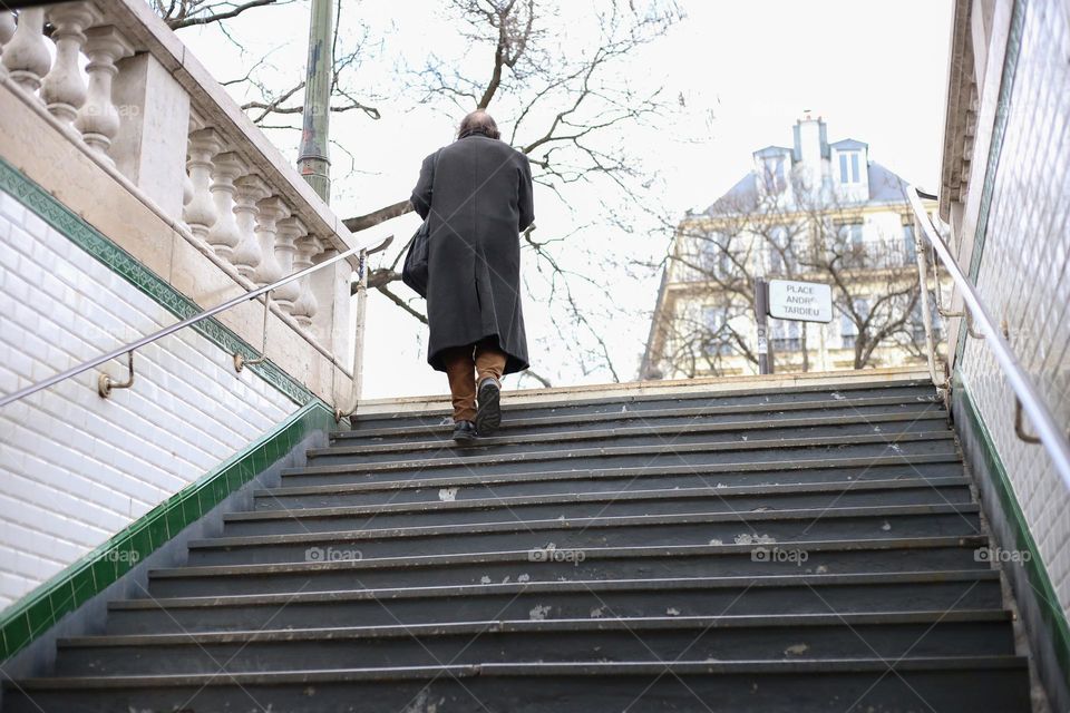 Lonely man walking on the stairs 