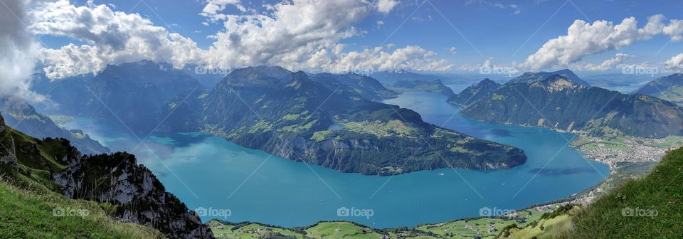 Beautiful panoramic view of the cantons and mountains with white clouds in the sky in Switzerland, close-up side view.