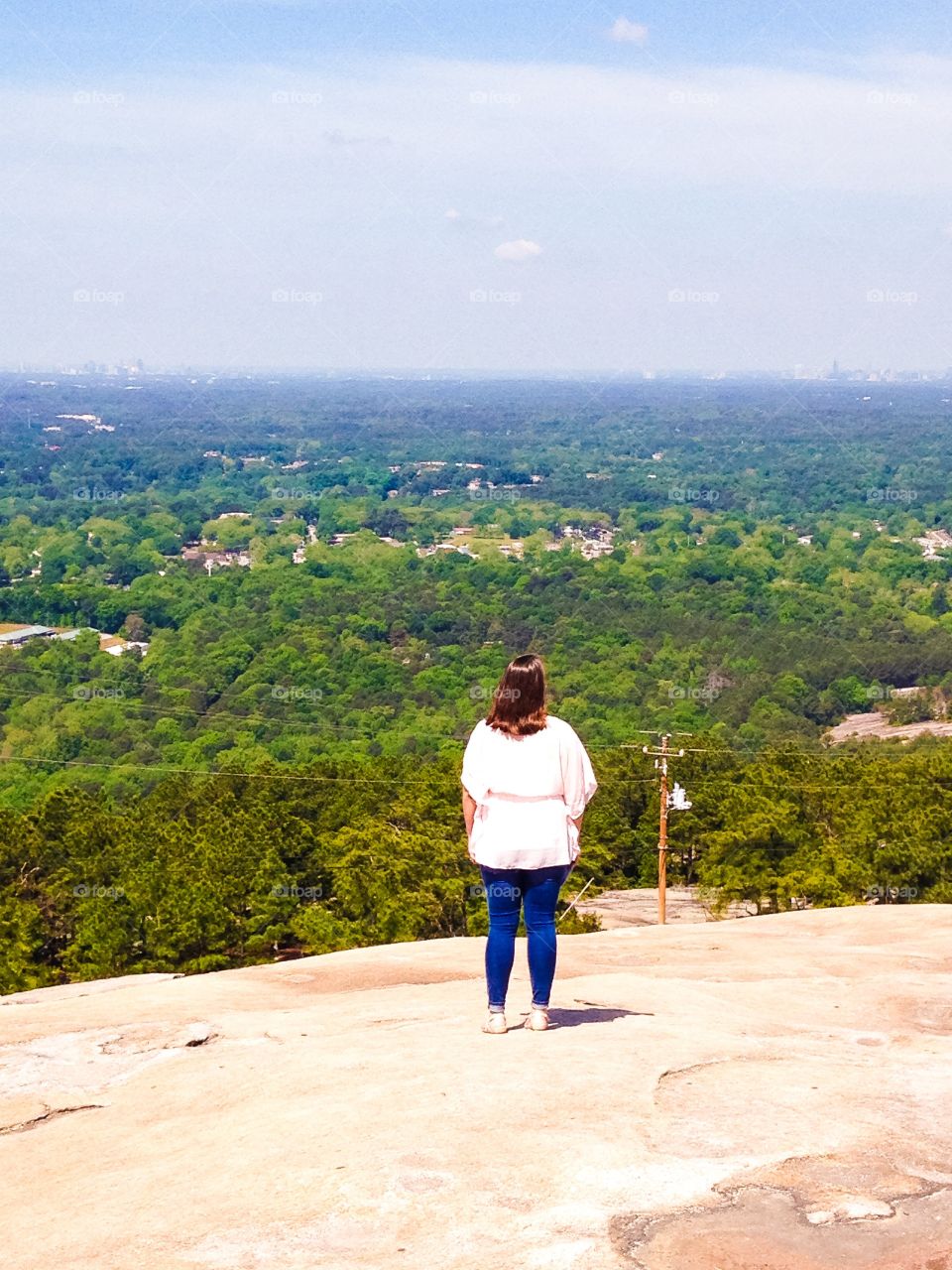 My wife standing on Stone Mountain overlooking the Atlanta skyline.