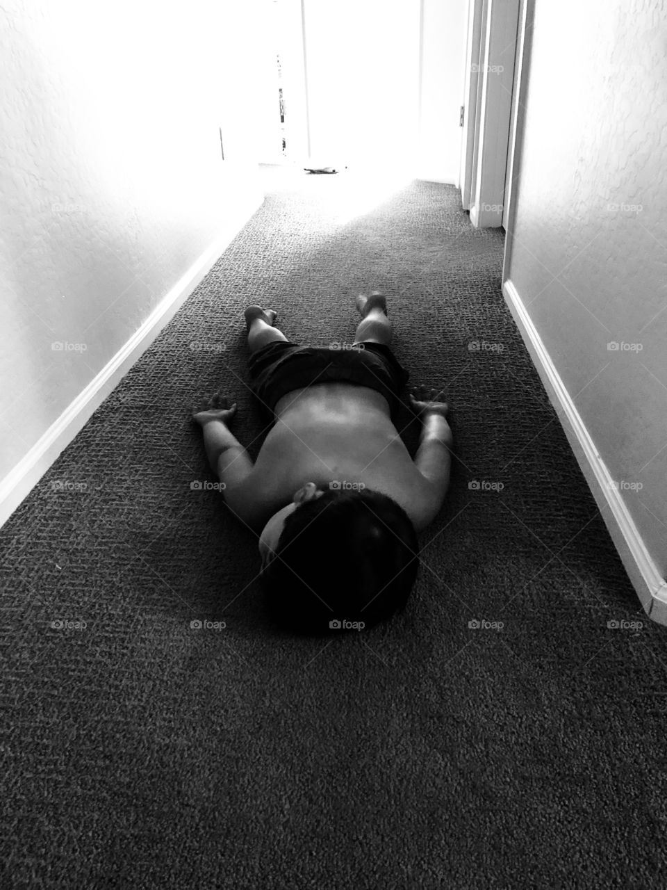 Boy laying face down on floor