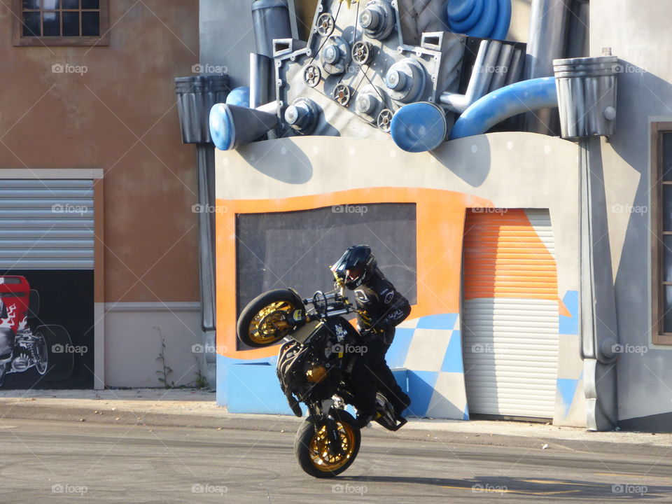 Show with motorcycle,wheelies and turns in action
