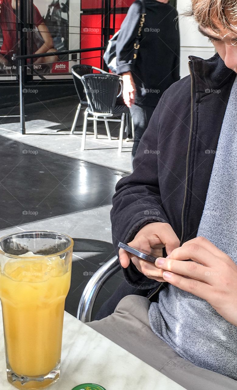 Outdoor cafe man using mobile phone 