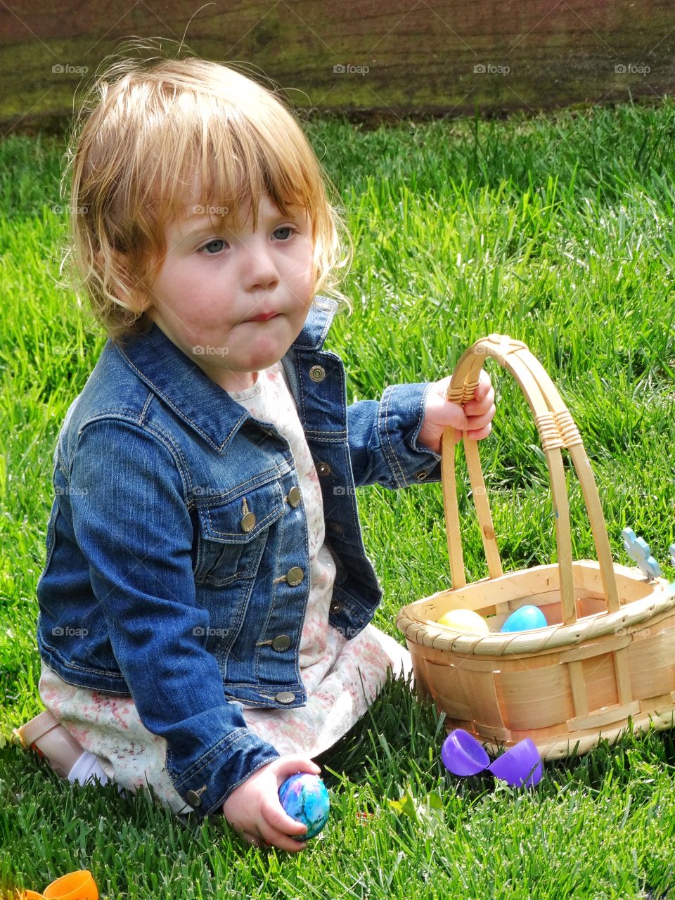 Girl With Easter Basket. Redhead Toddler Girl On The Grass With Easter Basket
