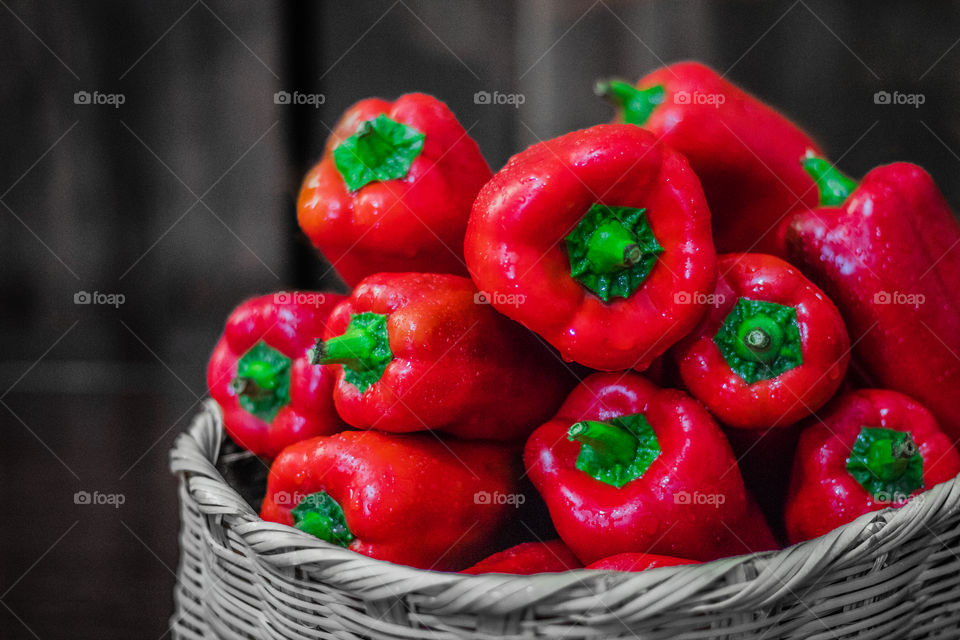Basket full of red bell peppers.