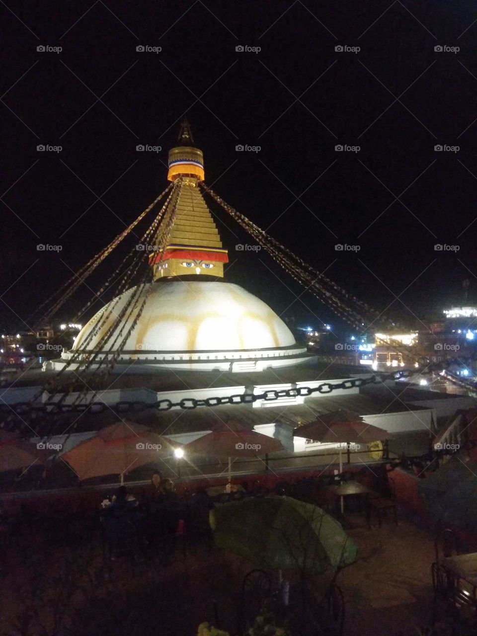 Boudhanath stupa in the evening time. shot from a cafe on the roof